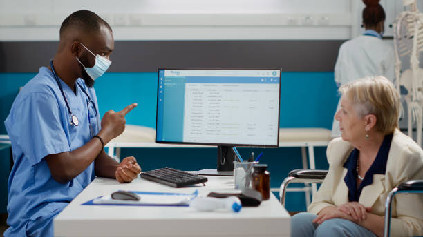 istock Specialist consulting old woman with disability in office 1440433721