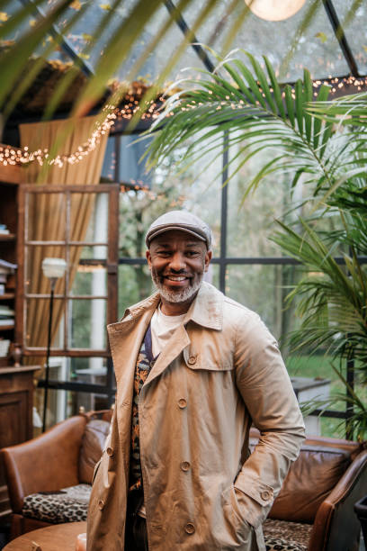 Lifestyle portrait of handsome black man Lifestyle portrait of handsome black man in an atypical cafe flat cap stock pictures, royalty-free photos & images