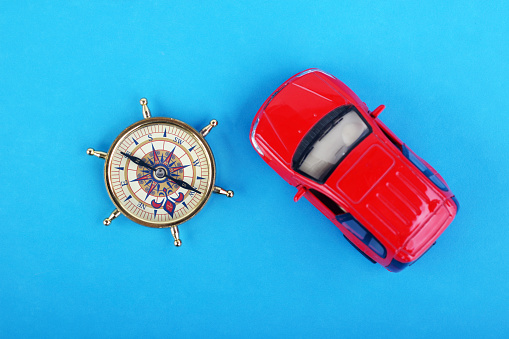 Tourist travel by car. Travel by car. Compass and car. Traveling across countries by land