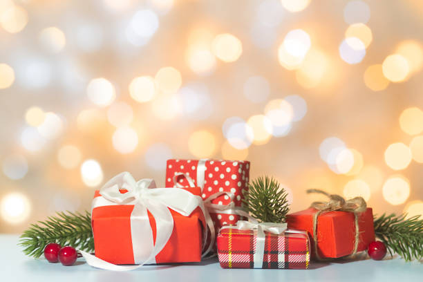 istock Christmas composition with red gift boxes with fir branches on bokeh lights background. Greeting card, Happy New Year and Merry Christmas. Copy space. 1440443760