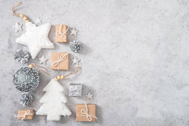 istock Christmas and new year frame, composition in neutral tones. Silver, white and beige decorations on gray concrete background. Flat flat, top view, copy space. Mockup for greeting card. 1440443771