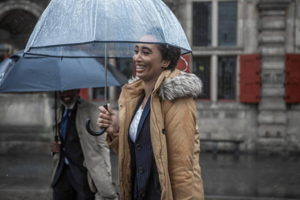 istock Two multi ethnic traveller colleagues commuting together in Delft on a rainy day 1440443894