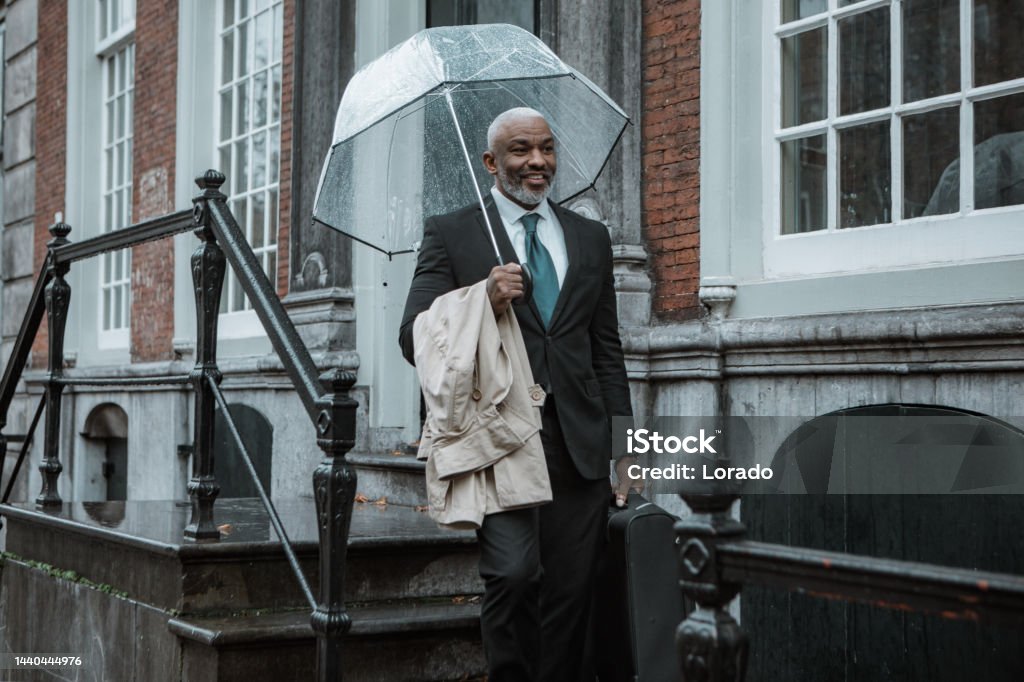 Black business man traveller commuting in Delft on a rainy day African-American Ethnicity Stock Photo