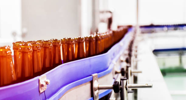 istock Beer bottle on conveyor belt into beer bottling process 1440447264