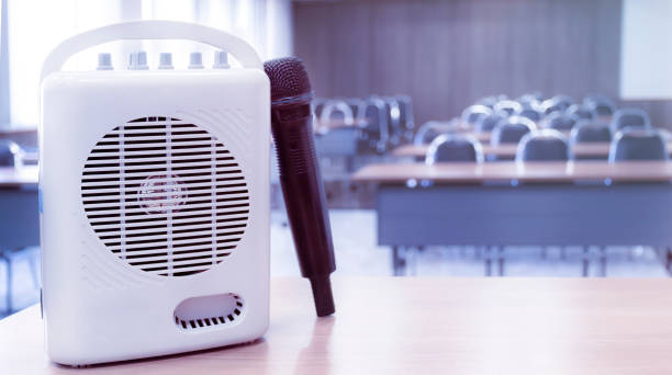 Pocket amplifiers and microphones placed on the table in front of the classroom. Pocket amplifiers and microphones placed on the table in front of the classroom. interview seminar microphone inside of stock pictures, royalty-free photos & images