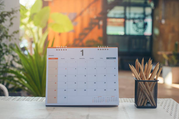 istock Desk for student education concept. Calendar, Pencils, book, note pad placed on School table for student work online and plan at home. 1440448798