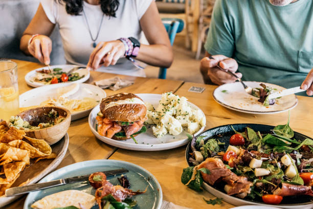 istock Gathering of unidentified people enjoying meal 1440448808