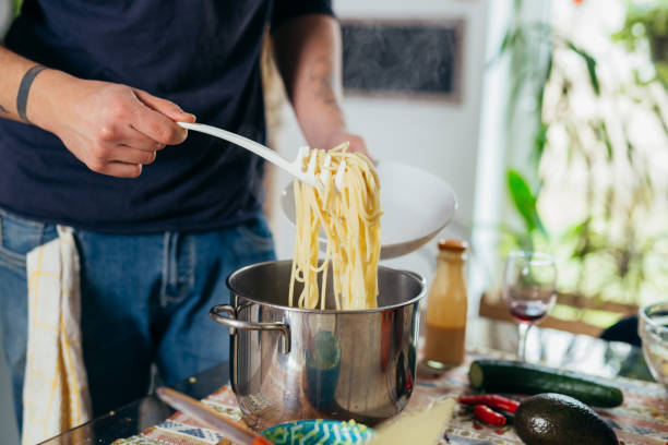 istock man prepares spaghetti at home 1440449003