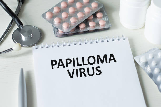 istock Medical concept. On a brown surface lies a stethoscope, pills and a notepad with the inscription - Papilloma Virus 1440450108