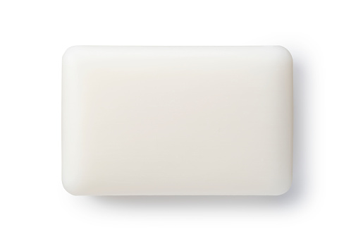 White solid soap placed on a white background. Viewed from directly above.