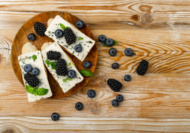 Blue Cheese on Bread Blue cheese on bread. Gorgonzola with berries and honey, bruschetta with ricotta, blueberries and blackberries, french toasts on wooden rustic background top view blue cheese stock pictures, royalty-free photos & images