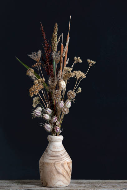 Beautiful dried flower bouquet in wooden vase. stock photo