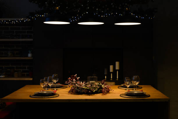 istock Christmas home table for two with candles lit by lamps above the table 1440454789