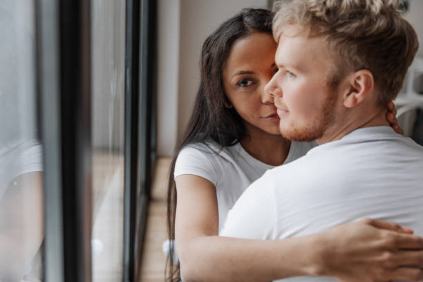 istock Affectionate lovely multiracial couple embracing with fondness 1440455957