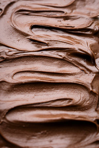 istock Bread toast with delicious chocolate cream. Chocolate cream texture with white background 1440456867