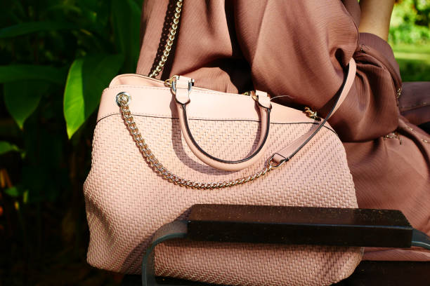 istock women carrying a pink purse 1440456882