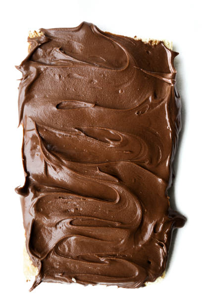 istock Bread toast with delicious chocolate cream. Chocolate cream texture with white background 1440457423