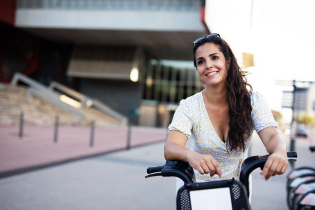 istock Beautiful girl using electric bicycle 1440457756