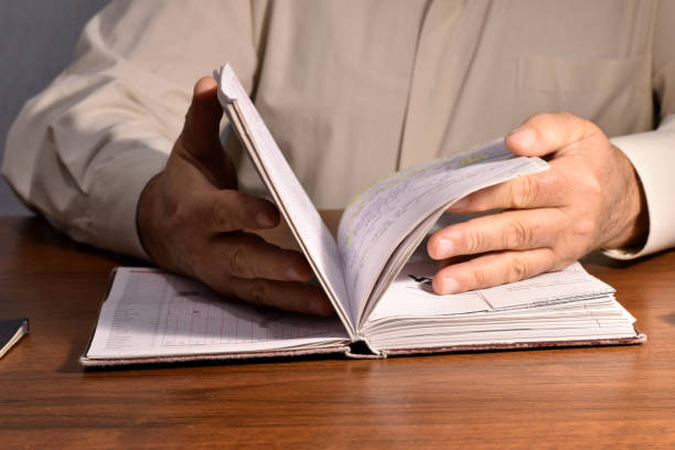 istock Man leafing through the pages of a notebook 1440458285