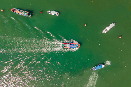 Vietnamese boats on the river. River pollution.