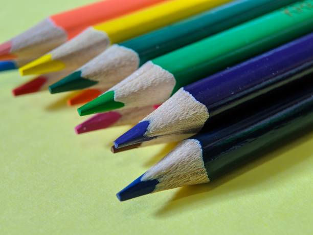 istock Close-up of colored pencils on yellow background 1440460449