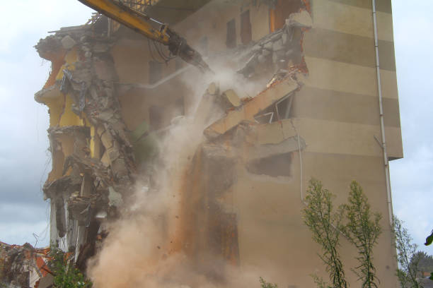 istock Excavator demolishing building 1440460512