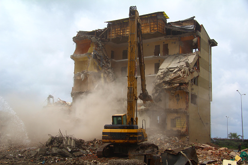 excavator demolishing building