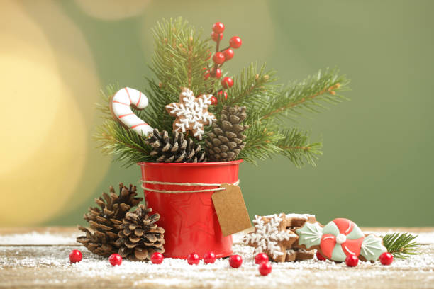 Festive natural, zero-waste, plastic-free, Christmas decoration. DIY winter holidays home decor made of fir branches, pine cones and red berries.