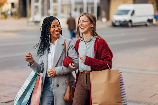 istock Two women are having crazy fun going from one shopping mall to another 1440462550