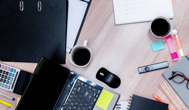 istock Top view laptop and coffee and accessories on table 1440462975