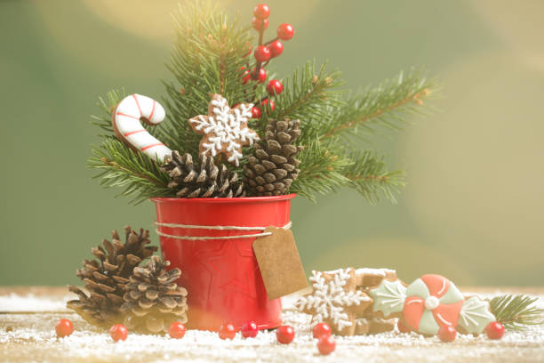 Festive natural, zero-waste, plastic-free, Christmas decoration. DIY winter holidays home decor made of fir branches, pine cones and red berries.