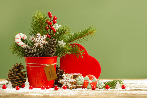 Festive natural, zero-waste, plastic-free, Christmas decoration. DIY winter holidays home decor made of fir branches, pine cones and red berries.