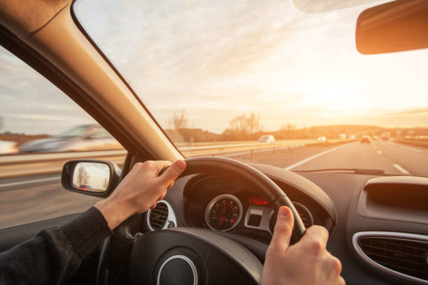 istock driving on highway, high speed, hands of driver 1440464335