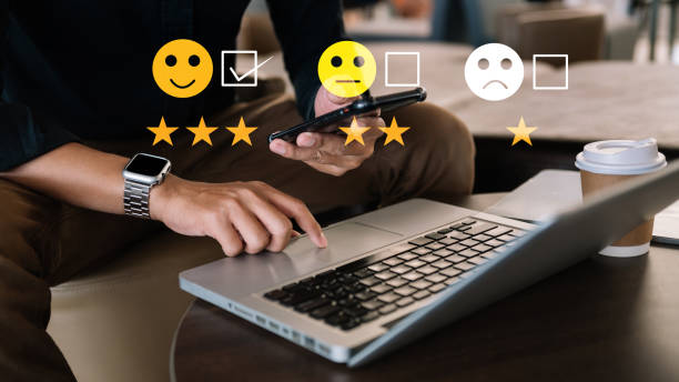 istock Customer service evaluation concept. Businessman pressing face smile emoticon show on virtual screen at tablet and smartphone 1440464568