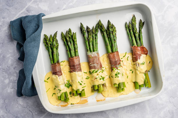 istock Asparagus Wrapped With Parma Ham and a Hollandaise Sauce. 1440465611