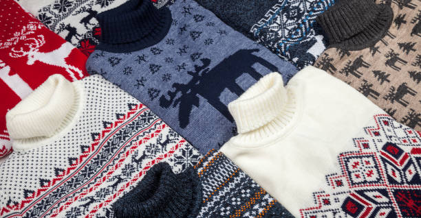 Collection of knitted Christmas sweaters for sale stock photo