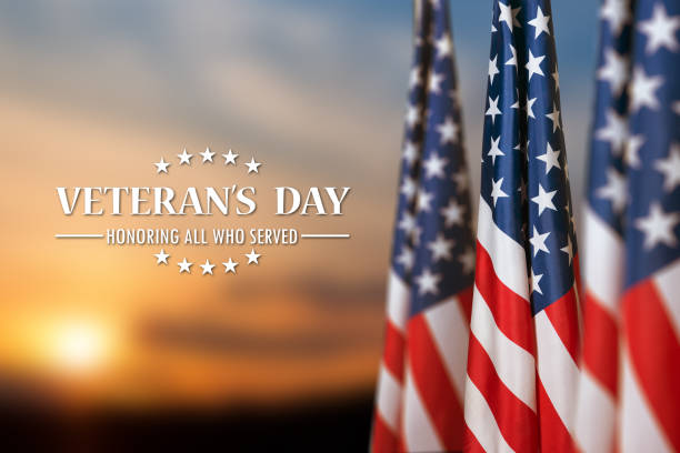istock American flags with Text Veterans Day Honoring All Who Served on sunset background. 1440467142