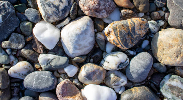 istock Rocks Water for Background. Pebble Stones Close-up. Vacation Holiday Recreation on Beach Concept. High Quality Photo 1440468781