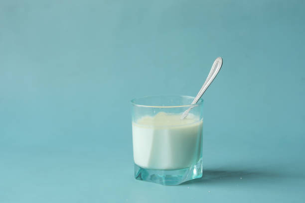 istock glass of milk and spoon on blue background 1440469128