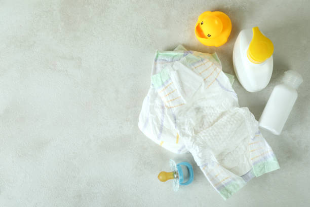 istock Baby hygiene accessories on white textured table 1440469484
