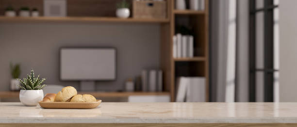 istock Copy space on white marble tabletop over blurred modern home workspace in background. 1440469542