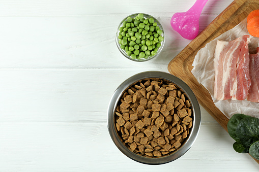Concept of organic pet food on wooden background