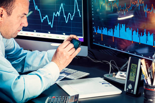 istock Businessman checking stock market data. He using a mobile phone. Analysis economy data on forex earn graph 1440471574