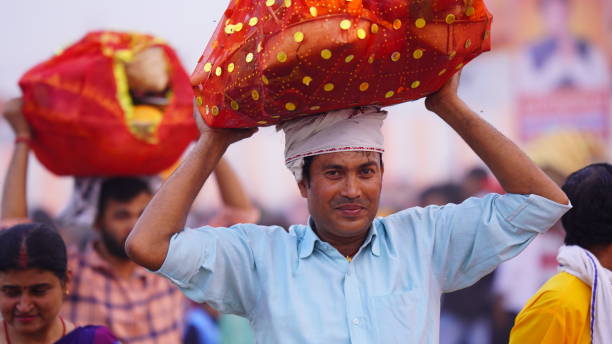 Nangloi, Delhi, India- 22 October 2022:A Devotee carries pooja or worship items for Chhath Puja