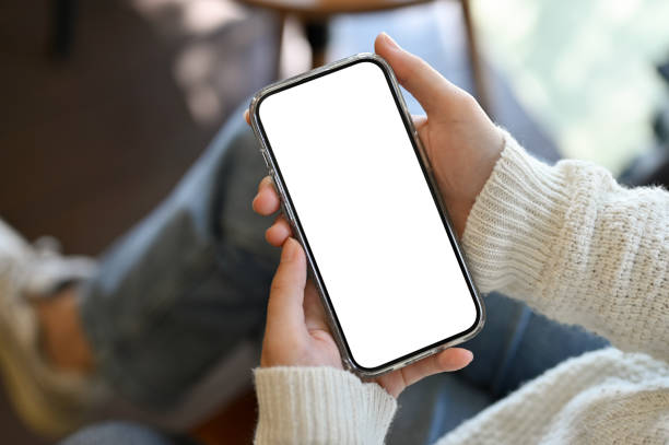 istock A female using her smartphone. smartphone white screen mockup. close-up image 1440472796