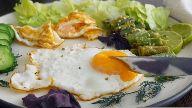 istock Healthy breakfast scrambled eggs green vegetables eaten with fork fill with energy whole day. Proper nutrition for health. Delicious breakfast with saturated fat proteins and fiber for balanced diet 1440473135