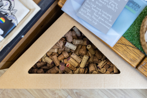 An overhead view of a cardboard unit holding recycled wine bottle corks in an eco shop in Northumberland.