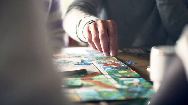 istock Elderly male human hand moving the pieces on a game board 1440476423