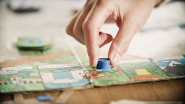 istock Close-up human hand moving the pieces on a game board 1440476438
