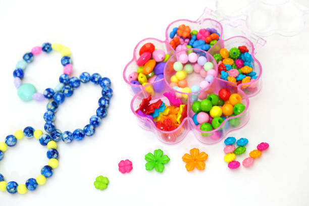 istock Set of multi-colored beads for needlework, child making jewelry at home. Easy and creative craft for children and teenagers 1440478122